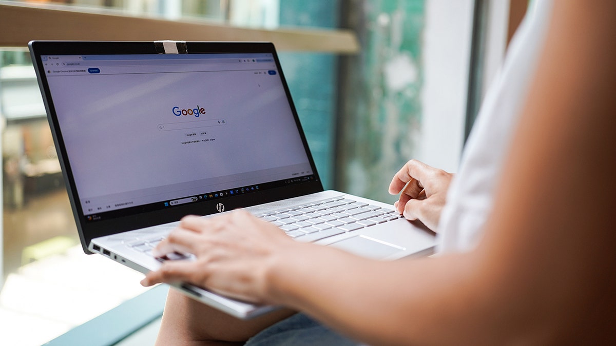 Person typing on their computer.