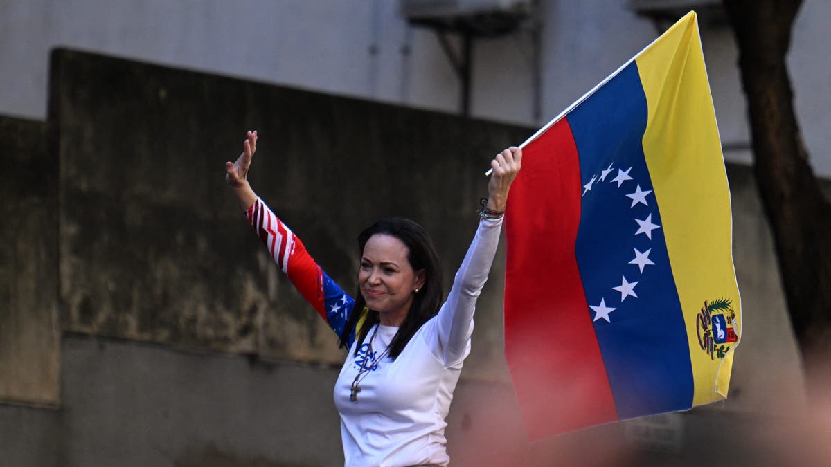 Venezuelan opposition leader Maria Corina Machado waves a national flag during a protest called by the opposition on the eve of the presidential inauguration, in Caracas on January 9, 2025.