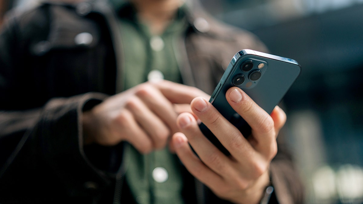 Man using smartphone, only his hands are shown