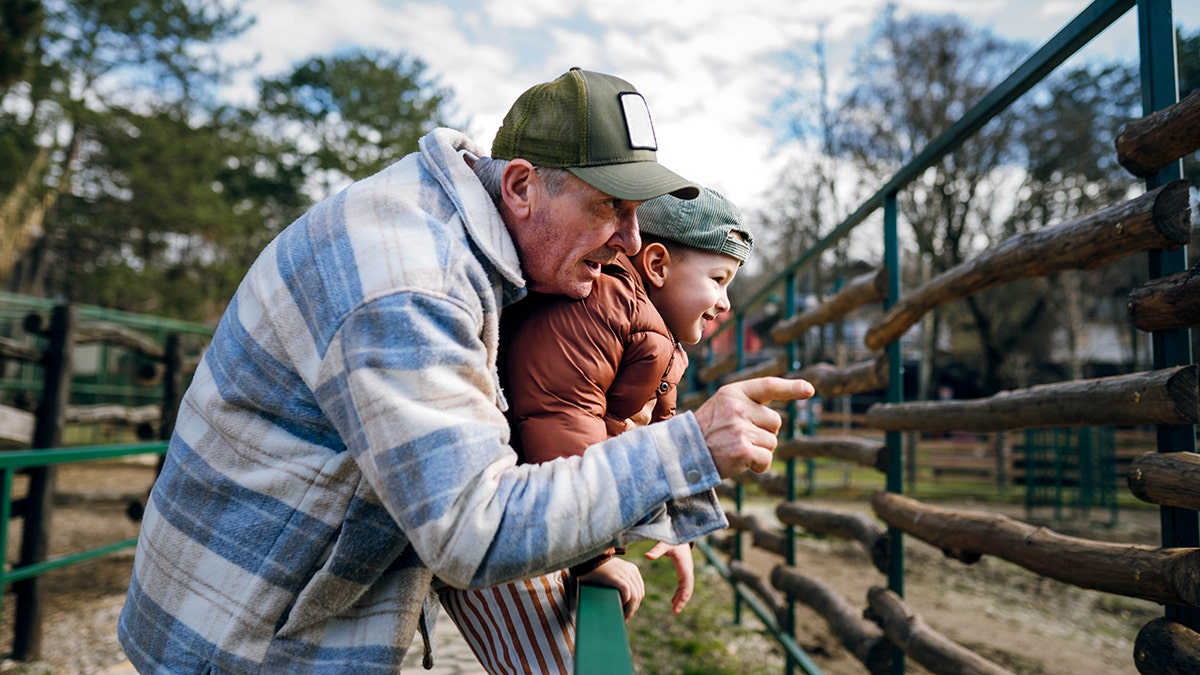 Grandfather took his grandson to the zoo
