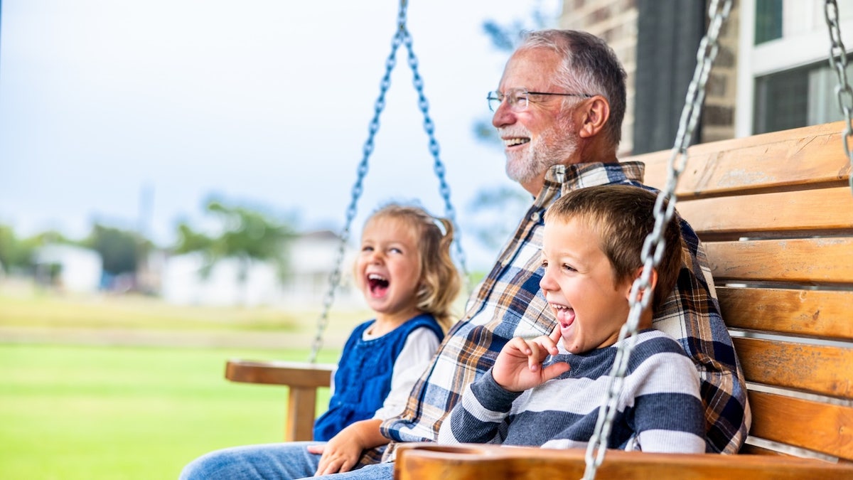grandpa with grandchildren on bench