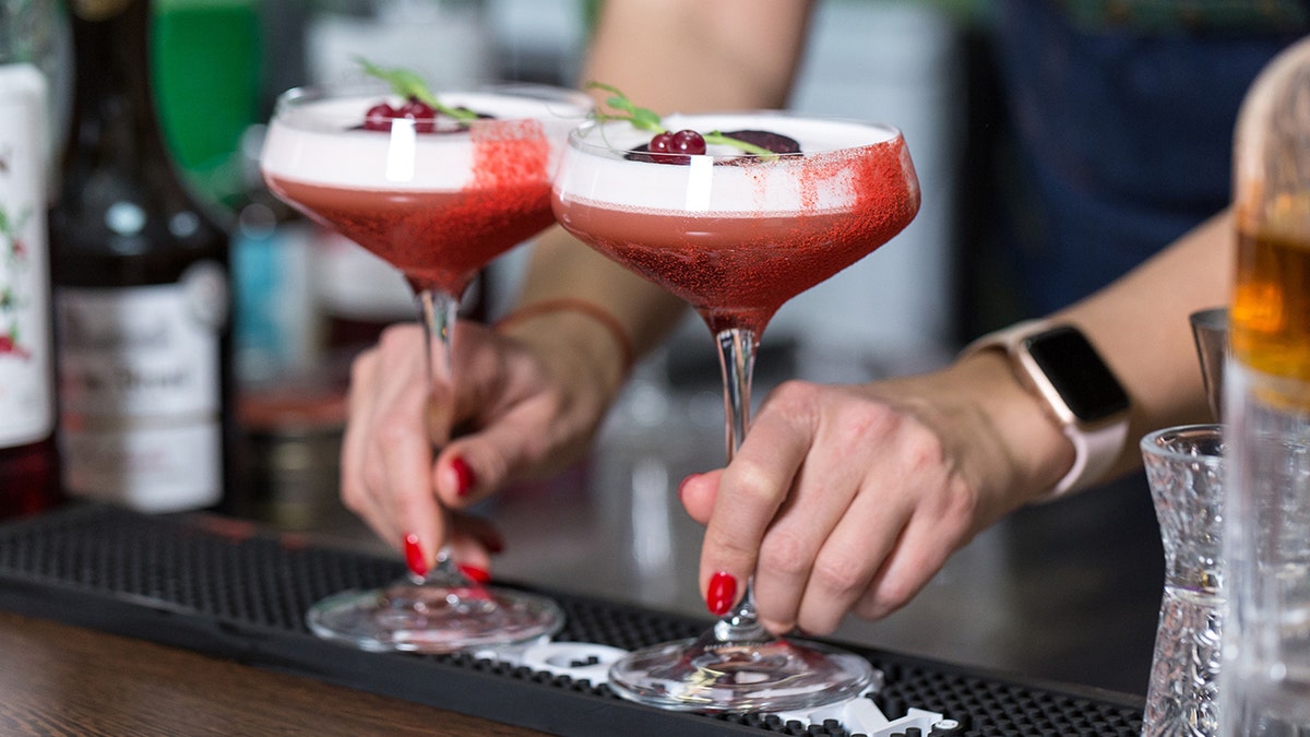 Holiday cocktails being placed on bar