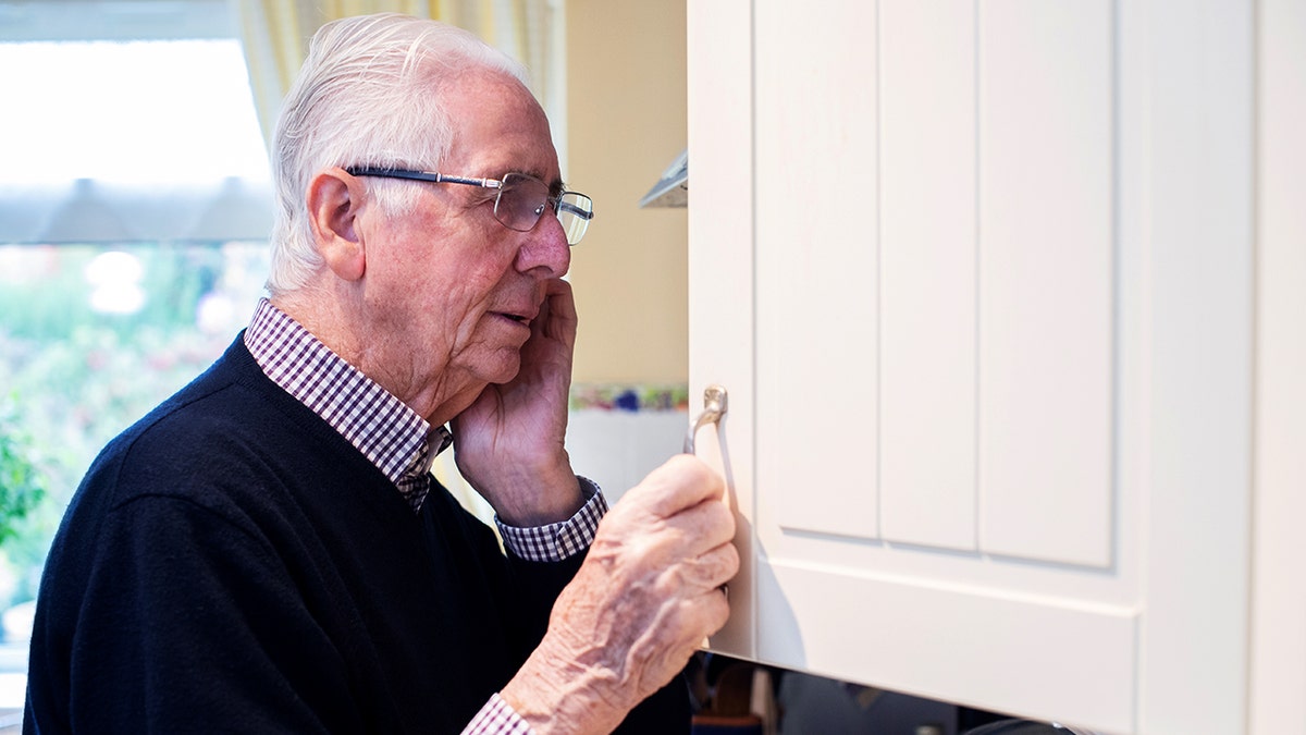 Old man looking into pantry