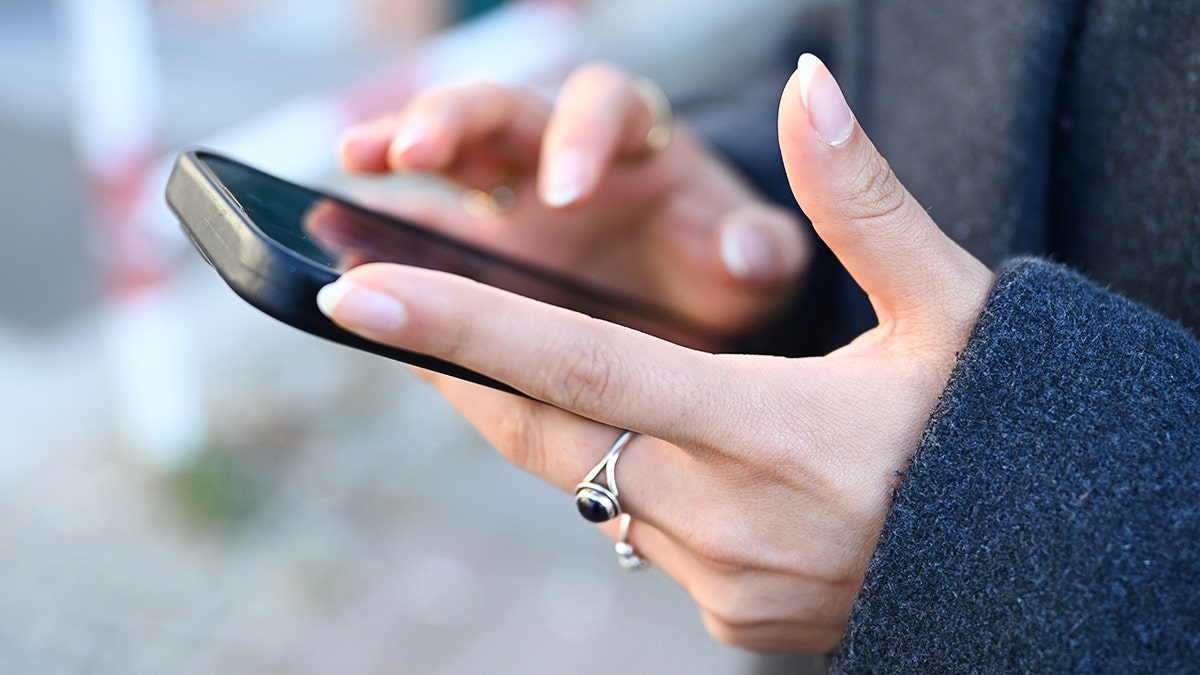 Woman typing on her smartphone.