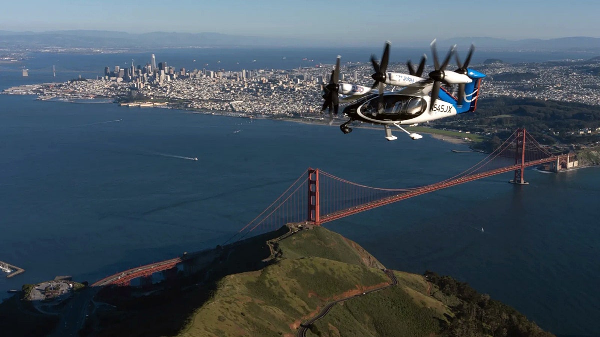 An air taxi flying over the Golden Gate Bridge in San Francisco