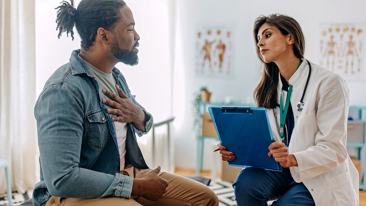 Doctor talking to man about his heart pain