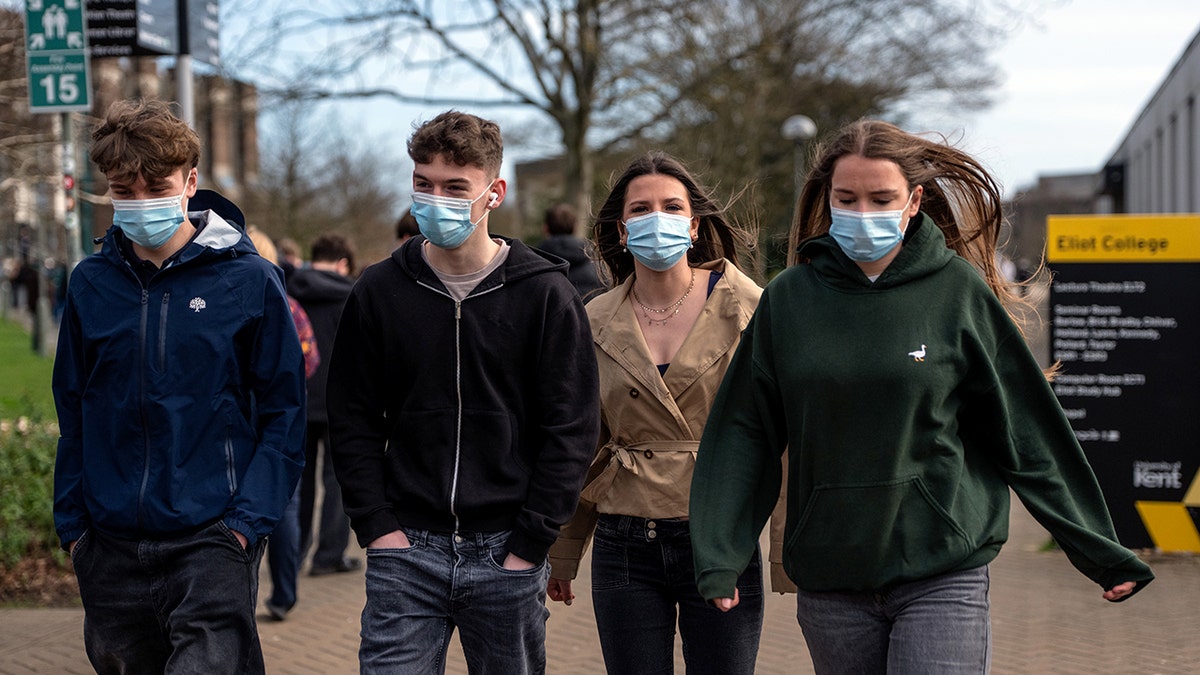 Students wearing face masks walk through the University of Kent in Canterbury campus after an outbreak of meningitis caused the deaths of two people, on March 16, 2026 in Canterbury, United Kingdom.