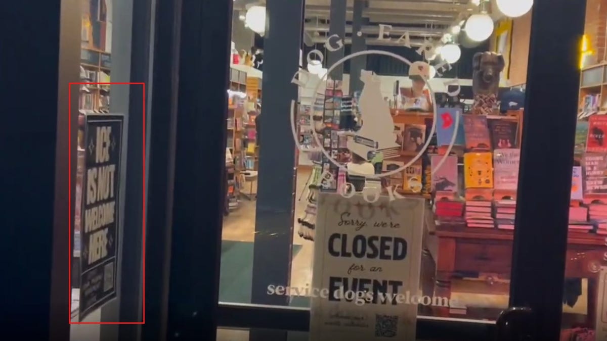 Image of Dog-Eared Books during campaign event for Zach Wahls shows anti-ICE poster in window
