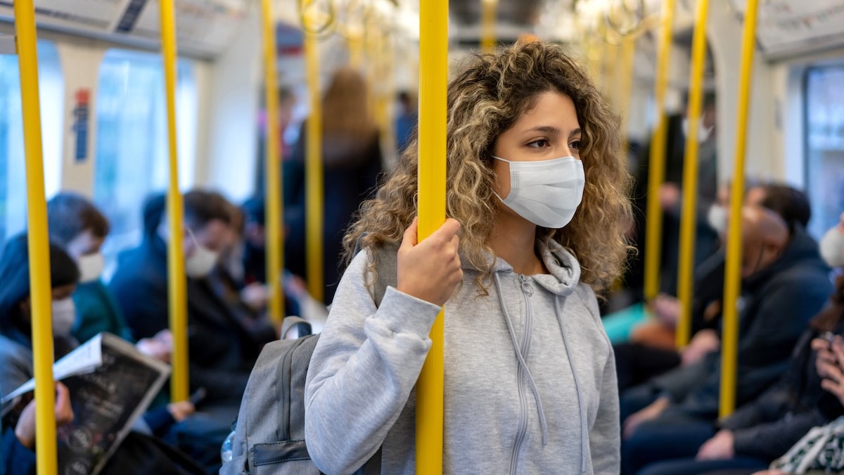 Girl wearing mask on train