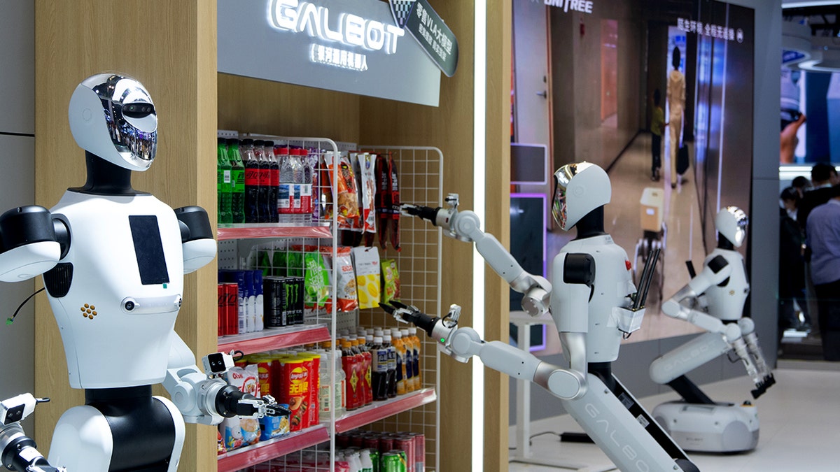 Humanoid robots stand in a store.