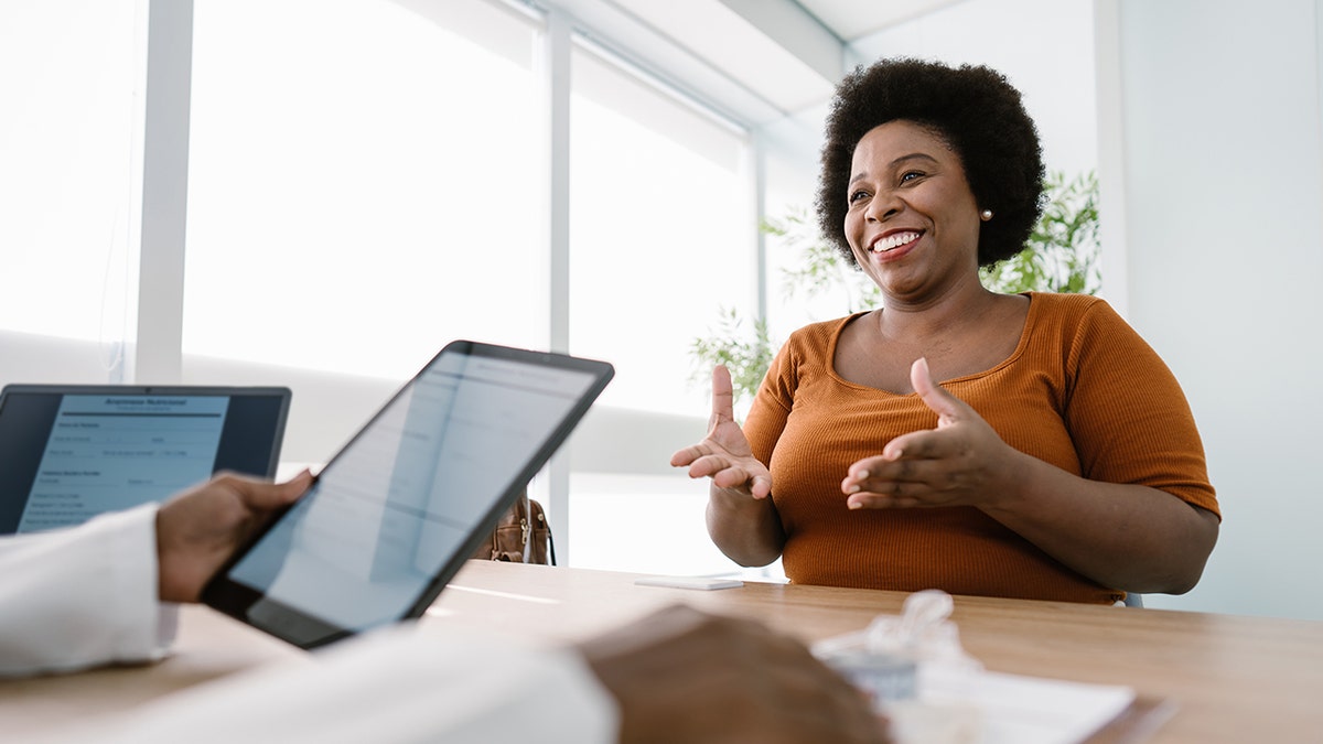 A nutritionist consulting with a client in an office setting
