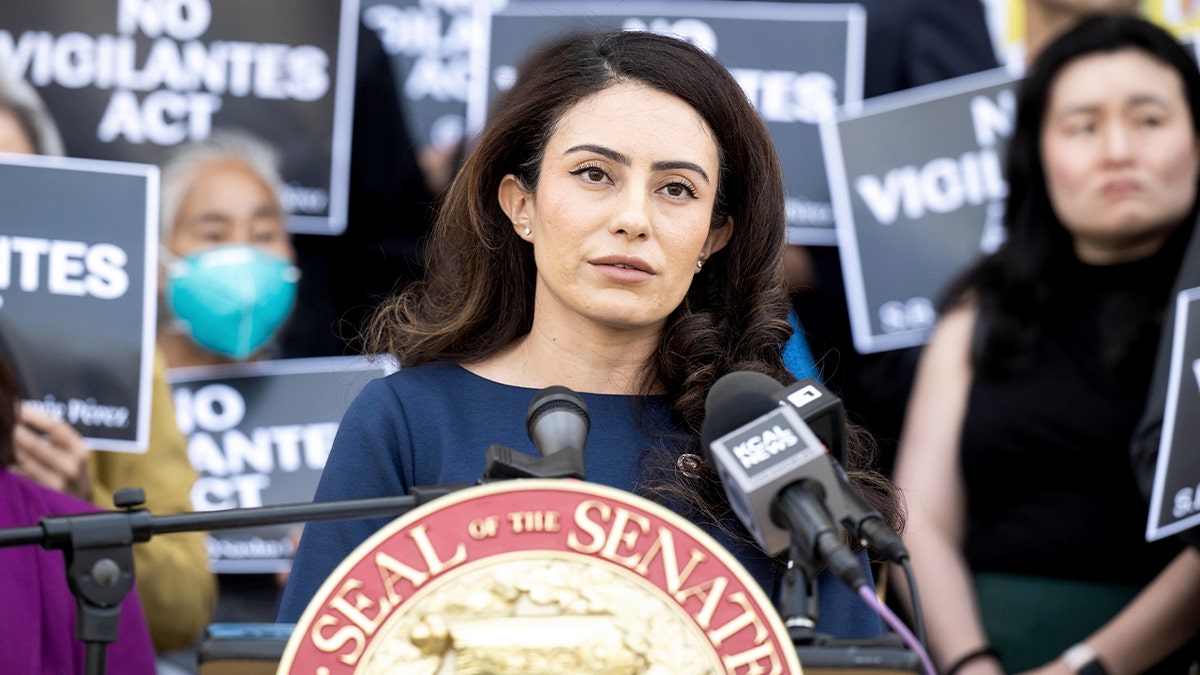 California State Sen. Sasha Renée Pérez speaking at a podium during a press conference at Pasadena City Hall.