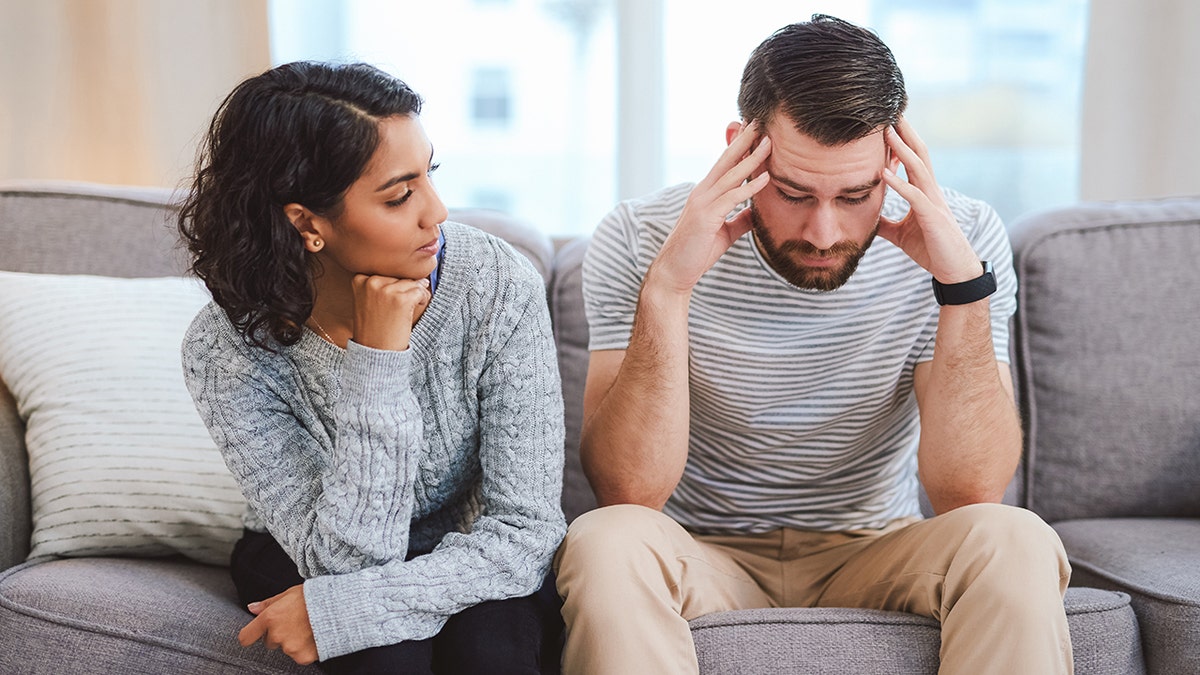 man and woman in stressed conversation
