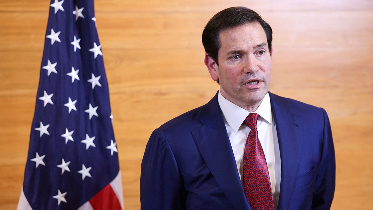 Secretary of State Marco Rubio addresses journalists inside an airport terminal before departing St. Kitts.