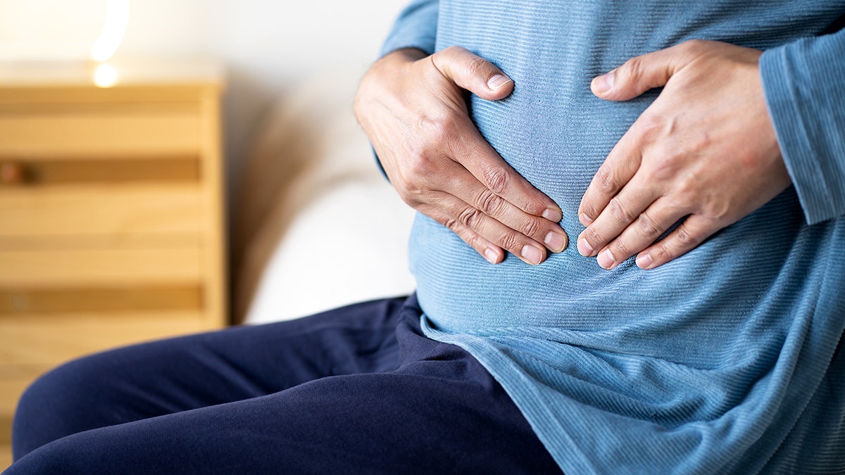 Man holding stomach in pain