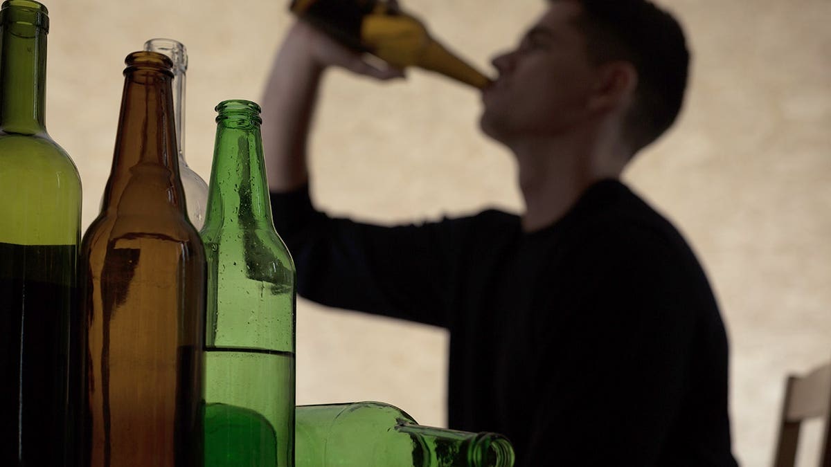 Teenager drinking beer from a bottle