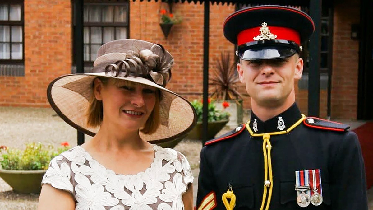 Rob Homans and Dawn Turner smiling together outside a brick building.