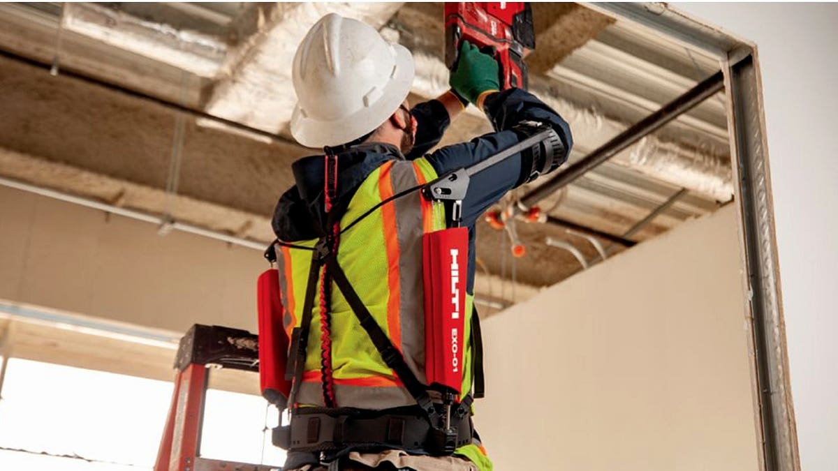 A worker wearing an industrial exoskeleton while working