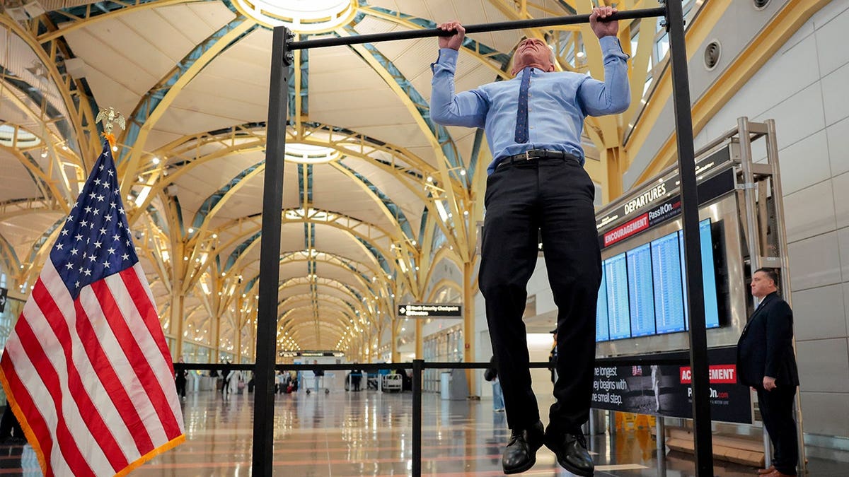Human Services Secretary Robert F. Kennedy Jr. doing pull-ups indoors.